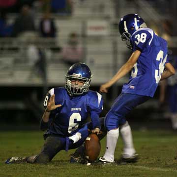 Josh Lowery (38) kicks an extra point out of the hold of Austin Powell (6). (Photo by Rick Nation)
