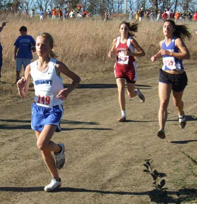 Ashlyn Lessenberry, left, keeps pace ahead of a pair of competing runners during Saturday's State cross country meet at Mountain Home. 