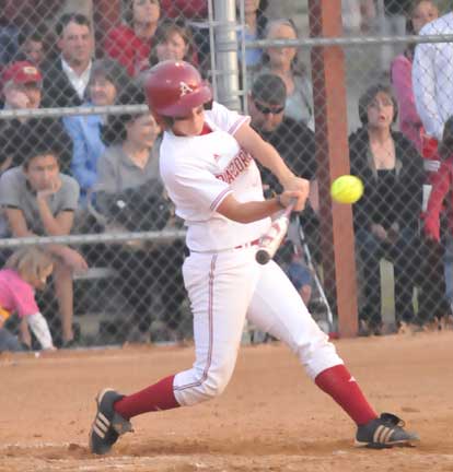 Amie Hubbard belts her fourth home run of the season as fans including her mother Joanie, right, look on. (Photo by Kevin Nagle)