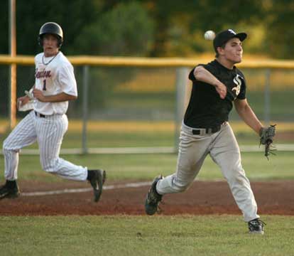 Hunter Mayall fired a throw to first after fielding a slow roller in the third inning of Friday's game at Benton. Seth Hobbs takes third on the play that Taron Green beat out for an infield hit. (Photo by Rick Nation)