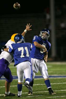 Wesley Akers (5), with the help of Tanner Gullett's block, releases a pass. (Photo by Rick Nation)