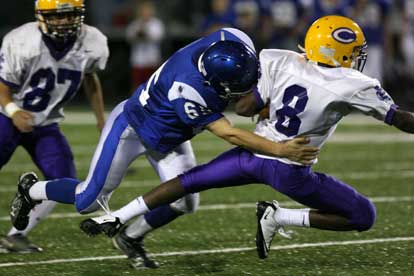 Bryant's James Gibson makes a tackle on Catholic's Jeffrey Cathey. (Photo by Rick Nation)