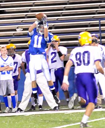 Austin Miller (11) goes high to haul down a pass in front of Scott Diaz (90). (Photo by Kevin Nagle)