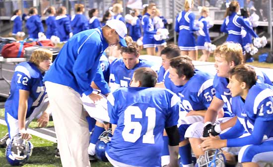 Bryant offensive line coach Kirk Bock goes over the blocking scheme with his players. (Photo by Kevin Nagle)