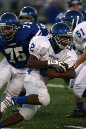 Mar'kevius Nelson (2) runs past Bryant Blue's Drew Allen (75) as Conner Chapdelaine (51) tries to get a block. (Photo by Rick Nation)