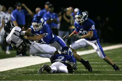 Dillon Winfrey (2), Jacob Brady (27) and Holden Chavis (30) converge to bring down Conway's Jalen Jones (1). (Photo by Rick Nation)