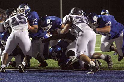 Hayden Lessenbery sneaks into the end zone to cap the Hornets' opening drive, running behind Justin Rauch (73), Landon Pickett (on the ground) and Colby Maness (79). (Photo by Rick Nation)