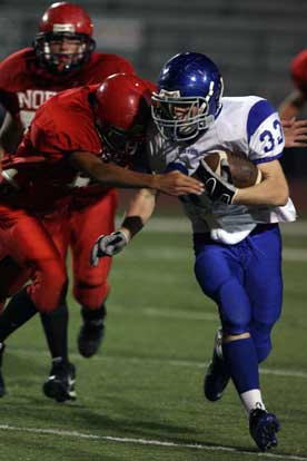 Austin May (33) looks for extra yardage. (Photo by Rick Nation)