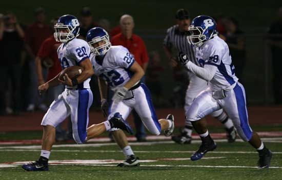 Tanner Tolbert (20) returns a kickoff with an escort from Jacob Powell (22) and Stephen Clark (29). (Photo by Rick Nation)