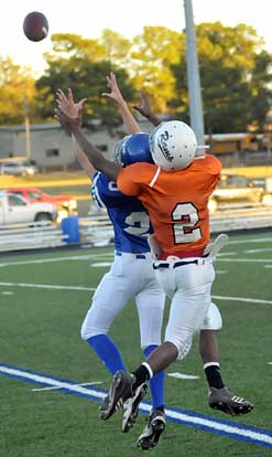 Trey Breeding (20) goes up in front of Ridge Road receiver Romello Jones (2).