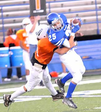 Jason Hastings hauls in a pass in front of Ridge Road defender. (Photo by Kevin Nagle)