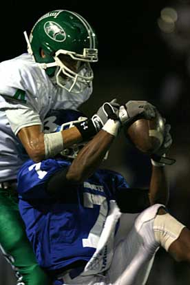 Bryant's Aaron Bell makes an interception in front of Van Buren receiver Joseph Snapp. (Photo by Rick Nation)