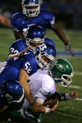 Bryant's Ben Seale (52) and his teammates bring down Van Buren quarterback Tyler Spoon. (Photo by Rick Nation)