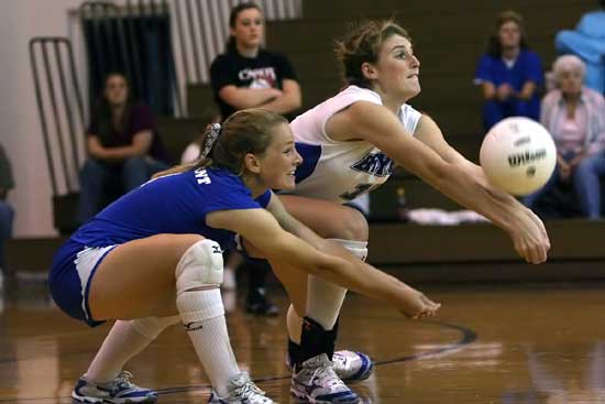 Lauren Reed, left, and Alyssa Anderson go for a dig. (Photo by Rick Nation)