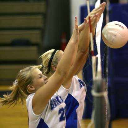 Amber Cope, front, and Morgan Hart to up for a block. (Photo by Rick Nation)