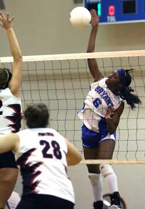 Bryant's Breanna White goes high above the net for a spike. (Photo by Rick Nation)