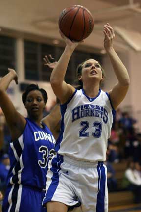Bryant's Kenzee Calley (23) goes up for a shot in front of Conway's Krista Robinson (32). (Photo by Rick Nation)