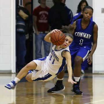Haley Montgomery loses her footing after driving around Conway's Taylor Gault. (Photo by Rick Nation)