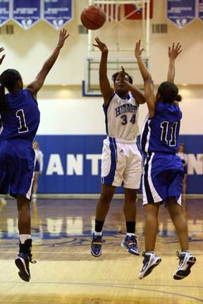 Bryant's Alana Morris (34) tosses up a shot between Conway's Taylor Gault (1) and Lauren McNeaill. (Photo by Rick Nation)