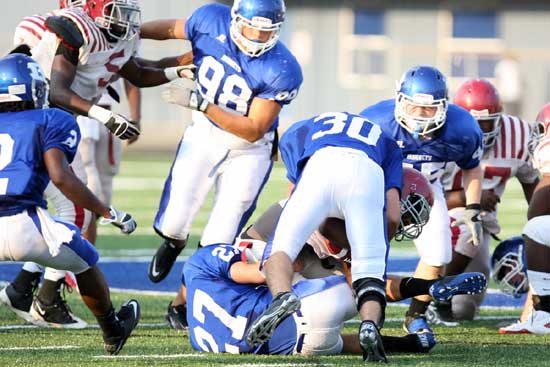Bryant's Josh Hampton (98) and Collin Chapdelaine (45) close in to help Holden Chavis (30) and Jacob Brady (27) on a tackle during Monday's scrimmage against Pine Bluff. (Photo by Rick Nation)