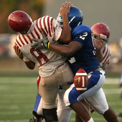 Bryant's James Kidd knocks the ball loose as he tackles the Pine Bluff quarterback. (Photo by Rick Nation)
