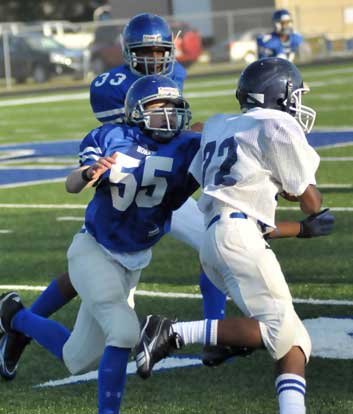 Bryant's Nic Jenkins (55) tracks down Conway running back Karlil Johnson (22). (Photo by Kevin Nagle)