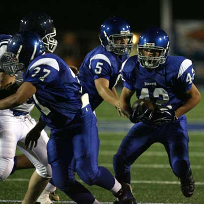 Colton Burton (42) takes a handoff from Wesley Akers and looks to run behind Colton Caviness (77). (Photo by Rick Nation)