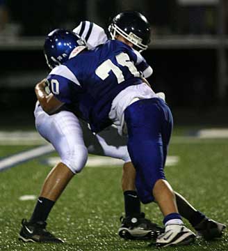 Hornets defensive lineman Tanner Rich (70) puts a hit on a Conway ball carrier. (Photo by Rick Nation)