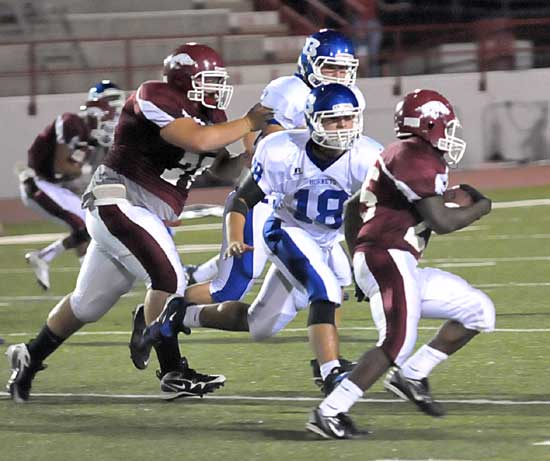 Bryant's Hunter Mayall (18) and Josh Hampton chase down a Texarkana ball carrier. (Photo by Kevin Nagle)