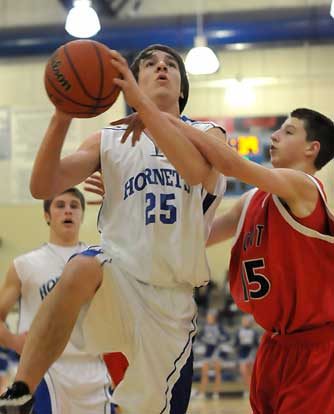 Chase Christie gets fouled by Cabot South's Hunter York on the way to the hoop as teammate Davis Nossaman trails the play. (Photo by Kevin Nagle)