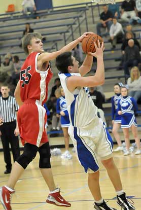 Cabot South's Blake Lucas blocks a shot by Bryant's Mitch Scoggins during Thursday's game. (Photo by Kevin Nagle)