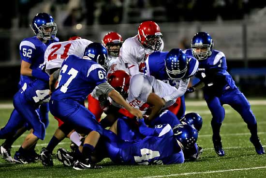 The Bryant defense including Devin Kelly (67), Matt Shiew (42), Ty Harris (1) and Austin Trusty (52) pile up Cabot North running back Alex Rodriguez during Thursday's game. (Photo by Rick Nation)