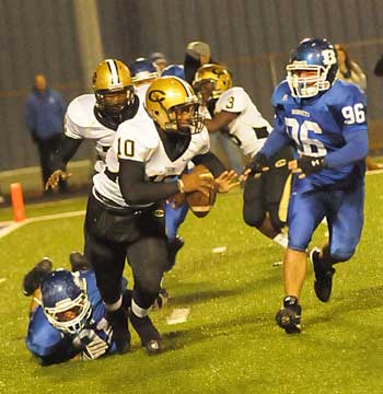 Tim Kelly (on ground) trips up Central quarterback Cammreon Polite (10) as teammate Austin Dunnahoo arrives to help out. (Photo by Kevin Nagle)