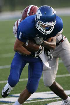 Sawyer Nichols (1) fights through a tackle on the way to his touchdown. (Photo by Rick Nation)