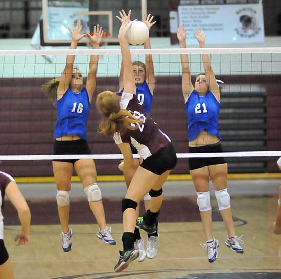 Bryant's Hannah Rice (16), Alyssa Anderson, and Courtney Davidson (21) go up for a block in Thursday's game against Benton. (Photo by Kevin Nagle)