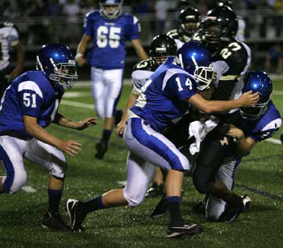 Bryce Hardin and Conner Chapdelaine help a teammate with a tackle on Hot Springs' Trey Lenox. (Photo by Rick Nation)