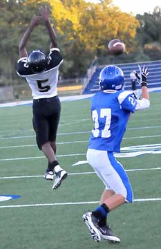 Bryant's Jason Hastings reaches for a pass dropped in over the leap of Hot Springs' D'Antre Campbell. (Photo by Kevin Nagle)