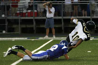 Bryant's Matt Shiew (42) drags down Hot Springs quarterback Anthony Goffigan. (Photo by Rick Nation)