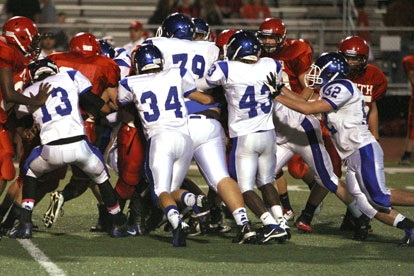 Bryant's Jaelyn Jones (13, Devon Alpe (34), Noah Love (79), Khaliq Slater (43) and Peyton Robertson (52) pile up a Cabot North run. (Photo by Rick Nation)