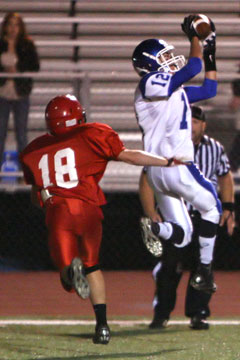 Evan Lee (12) leaps for one of his two touchdown receptions. (Photo by Rick Nation)