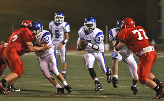 Savonte Turner (37) sprints through a gaping hole in the Cabot North defense produced in part by blocking from Drew Alpe (33) and Jacob Hall (58). (Photo by Rick Nation)