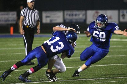 Bryant's Jaelyn Jones (13) and Austin Blacklaw (69) sack Conway Blue quarterback Harold Ross for what wound up being the last play of Thursday night's game. (Photo by Rick Nation)