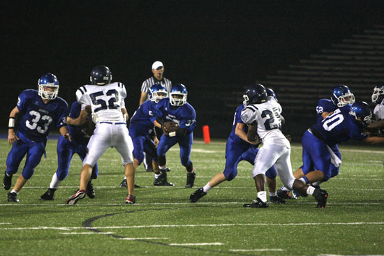 The Bryant offensive line clears the way for running back Savonte Turner. (Photo by Rick Nation)