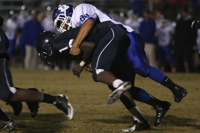 Bryant junior Amador Gaspar rides down Fair quarterback Demarious Robinson. (Photo by Rick Nation)