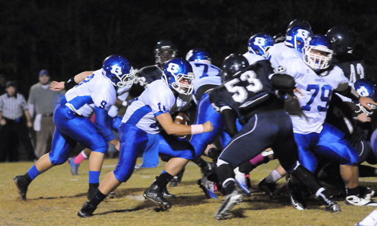 Bryant quarterback Hayden Lessenberry keeps with blocking help from Jordan Jones (79), Wesley Akers (9), Ian Shuttleworth (77) and the rest of the offensive line. (Photo by Kevin Nagle)