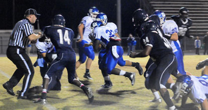 Hornets senior Tyree Reese (33) crashes towards the end zone off a block by Jacob Ward (50) and others. (Photo by Kevin Nagle)