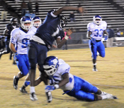 Cortez Williams (75) hits Fair's Demarious Robinson as he releases a pass. (Photo by Kevin Nagle)