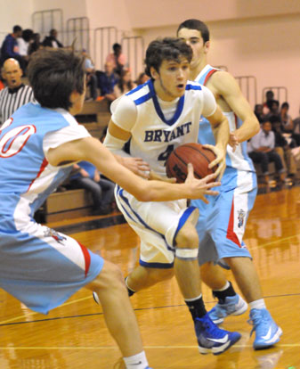 Bryant's Luke Rayburn splits a pair of Southside defenders on his way to the basket. (Photo by Kevin Nagle)