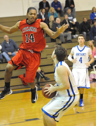 Zach Cambron (44) waits for Russellville's Dre Johnson to fly by before going up for a shot. (Photo by Kevin Nagle)