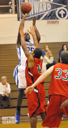 Greyson Giles launches a shot over Russellville's Dre Johnson. (Photo by Kevin Nagle)